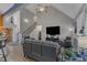 Bright living room featuring high ceilings, fireplace, staircase, and comfortable leather seating at 250 Highview Dr, Youngsville, NC 27596