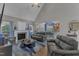 Open-concept living room with fireplace, hardwood floors, and connection to the kitchen and dining area at 250 Highview Dr, Youngsville, NC 27596
