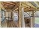 Outdoor bar area with wooden deck, sink, bar, and views of the wooded backyard at 250 Highview Dr, Youngsville, NC 27596