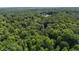 Aerial view showcases a secluded homesite, embraced by a lush canopy of dense and verdant forest at 2637 Buckeye Ct, Wake Forest, NC 27587