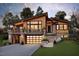 Striking home featuring a modern design, warm wood accents, stone details and a welcoming two-car garage at 2637 Buckeye Ct, Wake Forest, NC 27587