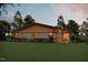 Single story house with wood and stone accents, complimented by professional landscaping and manicured lawn at 2637 Buckeye Ct, Wake Forest, NC 27587