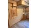 A quaint bathroom featuring striped wallpaper, wooden accents, and a sink at 2811 Chicken Bridge Rd, Pittsboro, NC 27312