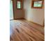 A naturally lit bedroom with wood floors and views of a deck at 2811 Chicken Bridge Rd, Pittsboro, NC 27312