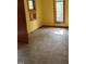An empty yellow bedroom with two windows and vinyl flooring at 2811 Chicken Bridge Rd, Pittsboro, NC 27312