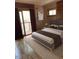 Modern bedroom with hardwood floors, a comfortable bed, and sliding glass doors at 2811 Chicken Bridge Rd, Pittsboro, NC 27312