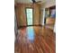 Inviting living room with beautiful hardwood floors, wood-paneled wall and a ceiling fan at 2811 Chicken Bridge Rd, Pittsboro, NC 27312