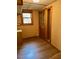 Functional room with light wood floors, patterned wallpaper, and a window at 2811 Chicken Bridge Rd, Pittsboro, NC 27312