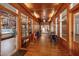 Inviting hallway featuring wood floors,paneled walls, display shelves and cozy seating areas with tables and chairs at 311 Culvert St, Apex, NC 27502