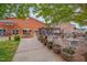 Charming outdoor patio with tables and seating, surrounded by lush greenery and a beautiful brick building at 311 Culvert St, Apex, NC 27502