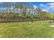 Large, well-maintained backyard with a stone wall and lush green grass, perfect for outdoor activities and relaxation at 345 Red Elm Dr, Durham, NC 27713