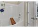 Clean bathtub with wood accessorie, and white tile surround, in a well-lit bathroom at 345 Red Elm Dr, Durham, NC 27713