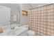 Cozy bathroom featuring neutral tones, a white vanity, toilet, and a shower with a decorative curtain at 345 Red Elm Dr, Durham, NC 27713