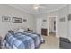 Cozy bedroom with natural light, complemented by a bed, ceiling fan, and an attached bathroom at 345 Red Elm Dr, Durham, NC 27713
