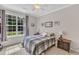 Bright bedroom with a large window and a bed with a gray and white checkered comforter at 345 Red Elm Dr, Durham, NC 27713