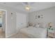 Bedroom featuring neutral palette, a bed, ceiling fan, bright window and double-door closet at 345 Red Elm Dr, Durham, NC 27713