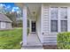 Welcoming front porch with white columns and a well-lit entryway at 345 Red Elm Dr, Durham, NC 27713