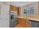 Stainless steel refrigerator and wood cabinetry in a kitchen at 345 Red Elm Dr, Durham, NC 27713
