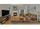 Comfortable living room featuring a fireplace, ample seating, and hardwood flooring at 345 Red Elm Dr, Durham, NC 27713