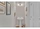Half bathroom featuring a pedestal sink, towel bar, and white door at 345 Red Elm Dr, Durham, NC 27713