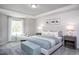 This primary bedroom offers a light neutral color scheme, plush carpet, and tray ceiling at 351 Fosterton Cottage Way, Raleigh, NC 27603
