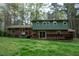 Expansive backyard featuring a wooden deck, with an exterior view from the home, set in a serene setting at 3518 Donnigale Ave, Durham, NC 27705