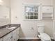 Bright bathroom with granite counters and a toilet at 3518 Donnigale Ave, Durham, NC 27705