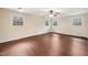 Large bedroom with wood-look floors, ceiling fan, and natural light at 3518 Donnigale Ave, Durham, NC 27705