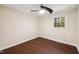 Cozy bedroom with wood-look flooring, fan, and natural light at 3518 Donnigale Ave, Durham, NC 27705