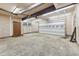 Unfinished garage space with concrete floors and a roll-up door at 3518 Donnigale Ave, Durham, NC 27705