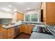 Bright kitchen with stainless steel appliances, stylish backsplash, and a window view of lush greenery at 3518 Donnigale Ave, Durham, NC 27705