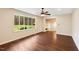 Bright living room featuring a large window with a view of the lush outdoors, and hardwood floors at 3518 Donnigale Ave, Durham, NC 27705