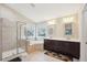 Bathroom featuring a soaking tub, separate shower, double vanity, and large windows for natural light at 4008 Sykes St, Cary, NC 27519