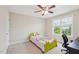 Well-lit bedroom includes a ceiling fan, a window for natural light, and light carpet at 4008 Sykes St, Cary, NC 27519