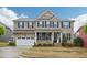 Beautiful two-story brick home with manicured lawn, attached garage, and inviting front porch at 4008 Sykes St, Cary, NC 27519