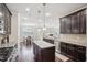 Modern kitchen boasts granite countertops, stainless steel appliances, and dark wood cabinets at 4008 Sykes St, Cary, NC 27519