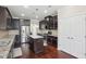 Gourmet kitchen featuring a central island, stainless steel appliances, and hardwood floors at 4008 Sykes St, Cary, NC 27519