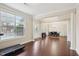 Spacious living room with hardwood floors, columns, large windows, and adjacent dining area at 4008 Sykes St, Cary, NC 27519