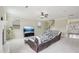 Bright living room with carpet, a ceiling fan, a sectional sofa, and large windows providing natural light at 4008 Sykes St, Cary, NC 27519