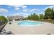 Community pool area featuring ample seating, mature trees, and a clubhouse at 4008 Sykes St, Cary, NC 27519