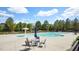 Community pool area with seating, umbrellas, and a mushroom fountain feature at 4008 Sykes St, Cary, NC 27519