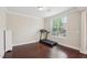 Room with wood floors and a treadmill next to a bright window, showing space for fitness at 4008 Sykes St, Cary, NC 27519