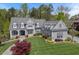 Aerial view of a gray home with manicured lawn, mature trees, and architectural details at 417 Westbury Dr, Chapel Hill, NC 27516