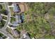 Stunning aerial view of a home with a pristine pool area, complemented by lush trees and neighborhood surroundings at 417 Westbury Dr, Chapel Hill, NC 27516