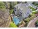Aerial view showcasing the home's backyard oasis, with a pool, spa, patio and ample greenery at 417 Westbury Dr, Chapel Hill, NC 27516