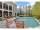 Beautiful backyard pool with a lounge area, comfortable chairs, and a spa, ideal for relaxation and entertaining at 417 Westbury Dr, Chapel Hill, NC 27516