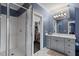 Bathroom featuring a glass-enclosed shower, gray cabinets, and ample vanity space at 417 Westbury Dr, Chapel Hill, NC 27516