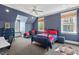 Bedroom showcasing blue walls, a ceiling fan, and multiple windows with views at 417 Westbury Dr, Chapel Hill, NC 27516