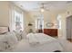 Comfortable bedroom with plush bedding, a ceiling fan, and stylish decor, offering a tranquil retreat at 417 Westbury Dr, Chapel Hill, NC 27516