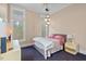 Cozy bedroom with a ceiling fan, large windows, and neutral colors at 417 Westbury Dr, Chapel Hill, NC 27516